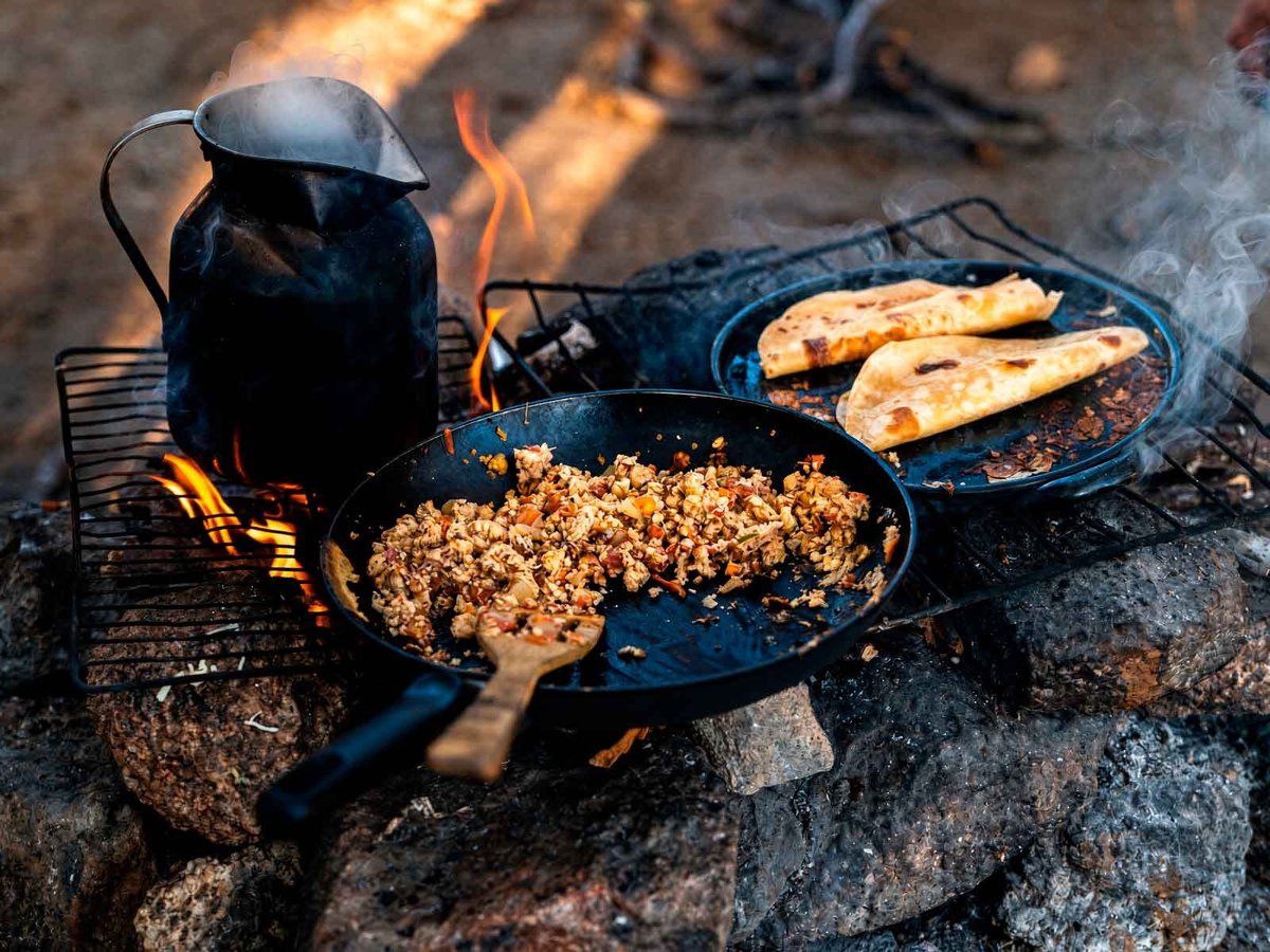 Camp cooking at El Segundo Valle on the Sierra La Laguna trek, skillet, kettle and bread over the fire