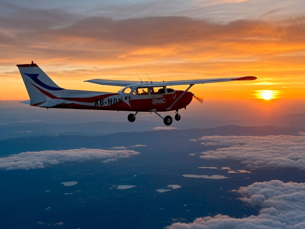 Contact Venturaleza — small plane flying over the Bay of La Paz at sunset